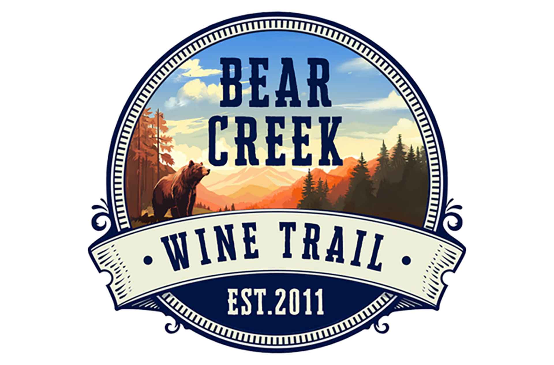 Bear Creek Wine Trail logo featuring a bear in a forest with mountains and sunset, text reads ‘Bear Creek Wine Trail Est. 2011.