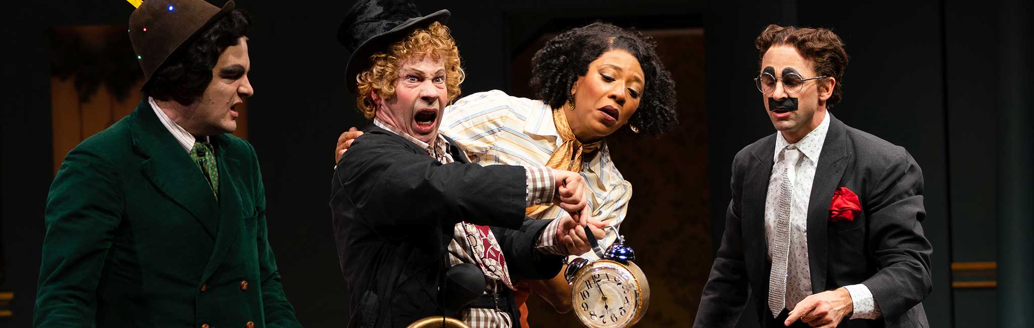 A slapstick comedy scene with four characters from the play.