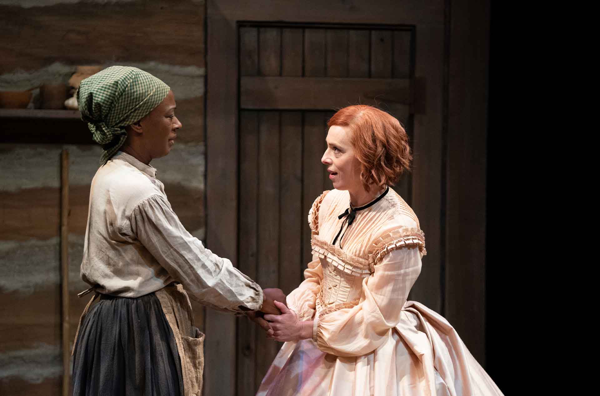 Two people holding hands and looking at each other.