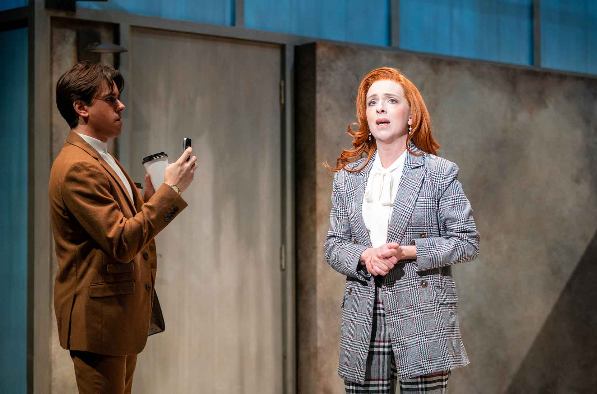 Person looking ahead while another person looks at them.