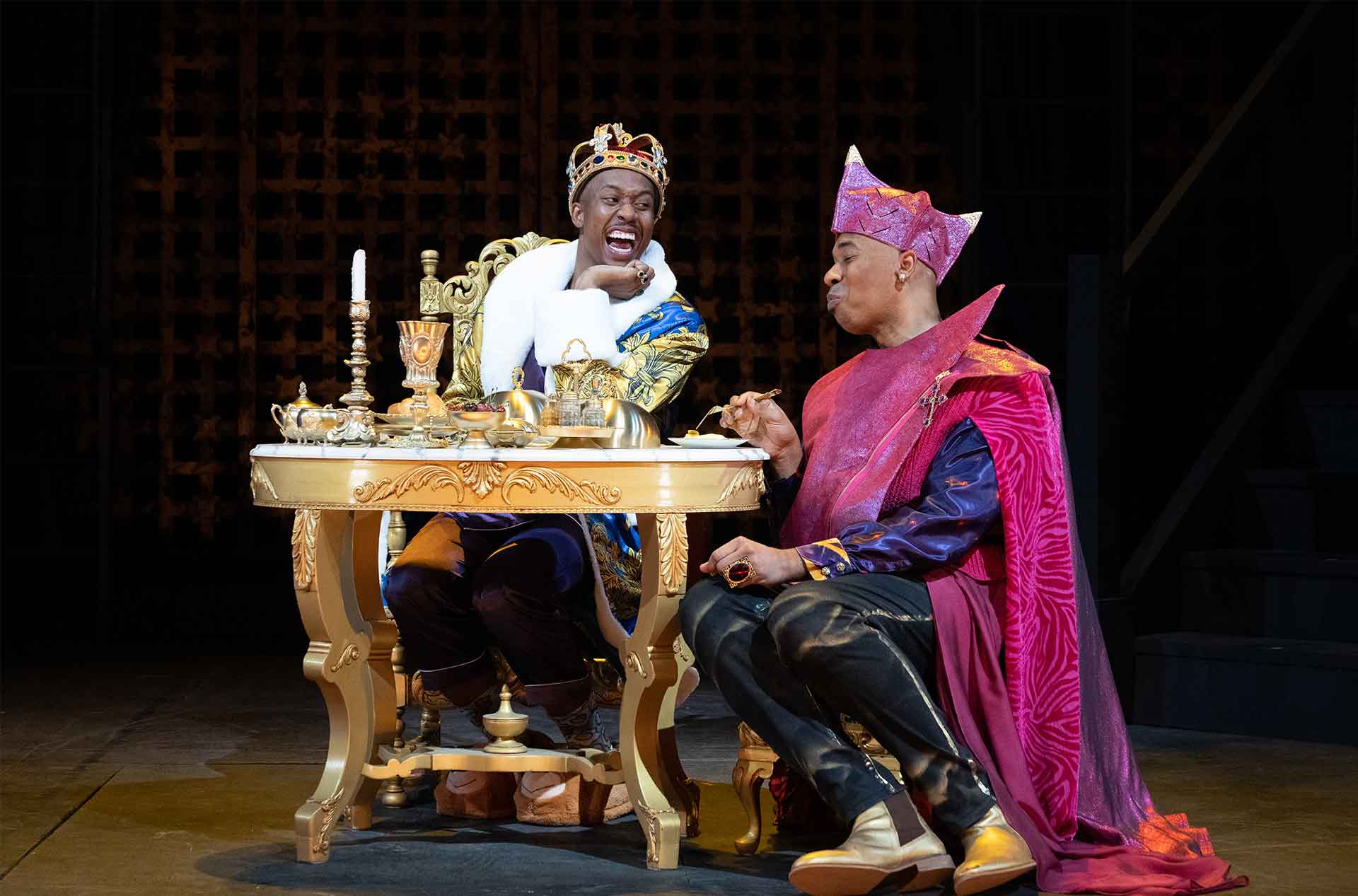 Two people eating and chatting at a table.