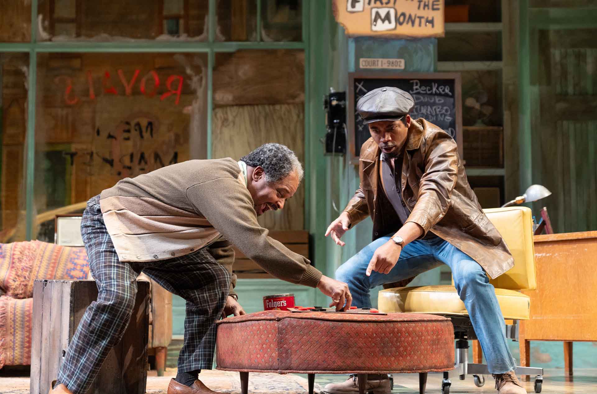 Two people are engaged in an intense game of checkers on a circular ottoman in a retro-styled room.