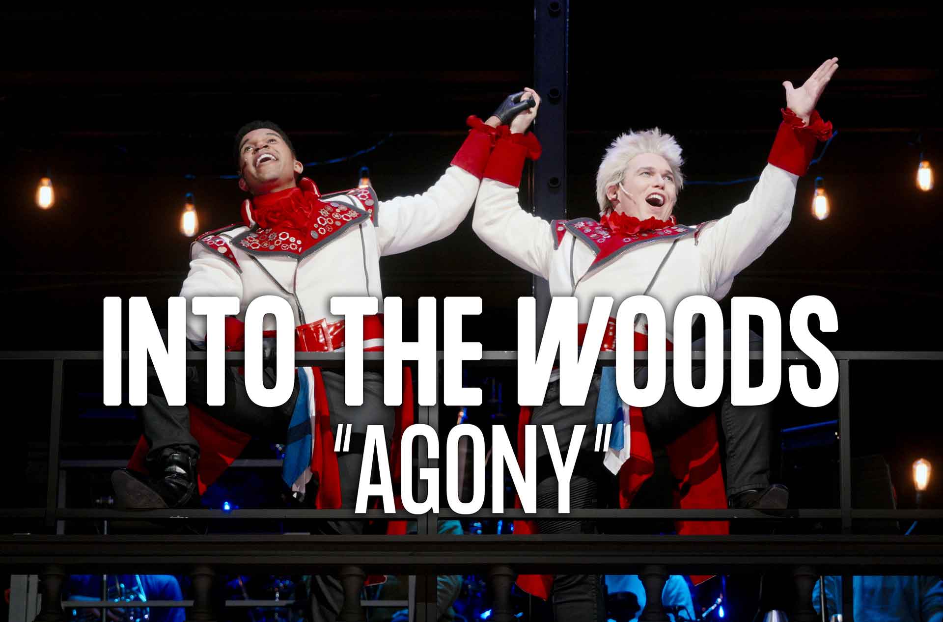 Two actors in identical, flamboyant white and red prince-like costumes strike a triumphant pose on a balcony, holding hands and gesturing boldly. White text reads: Into the Woods "Agony".