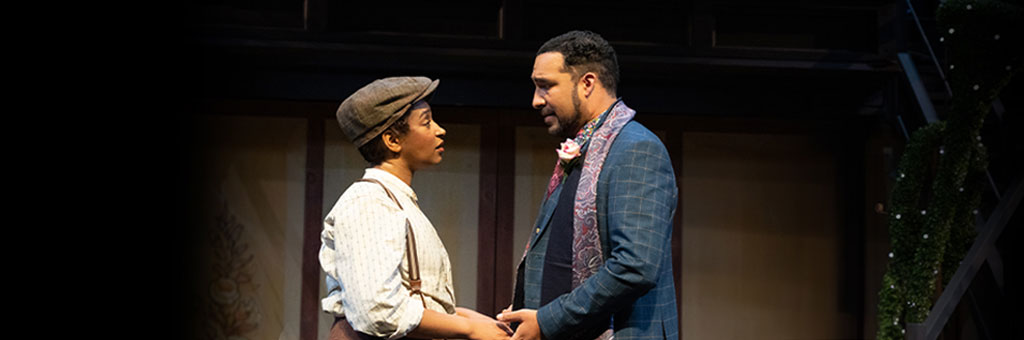 Two people holding hands looking into each others eyes.