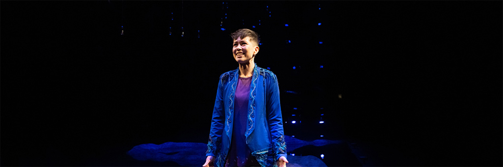 A person looking out into the distance smiling.