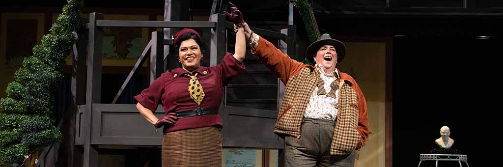 Two people holding hands up in celebrations.