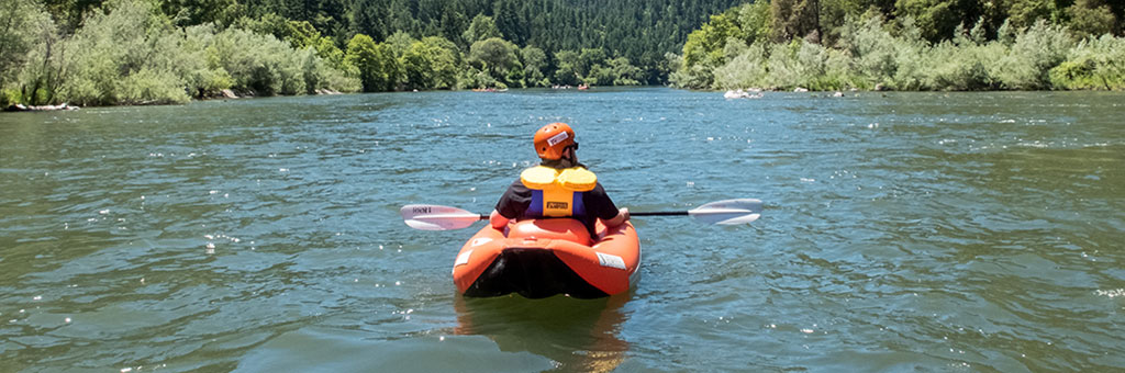 A person kayaking down a river.