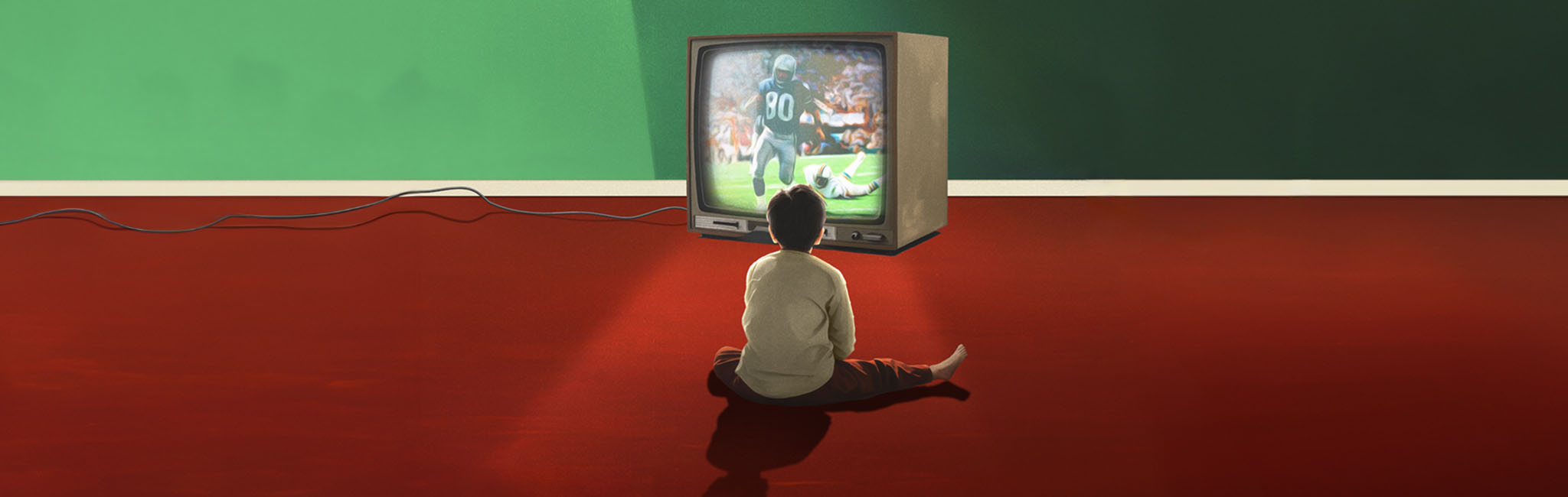 A boy sitting in front of a tv with a football game on.