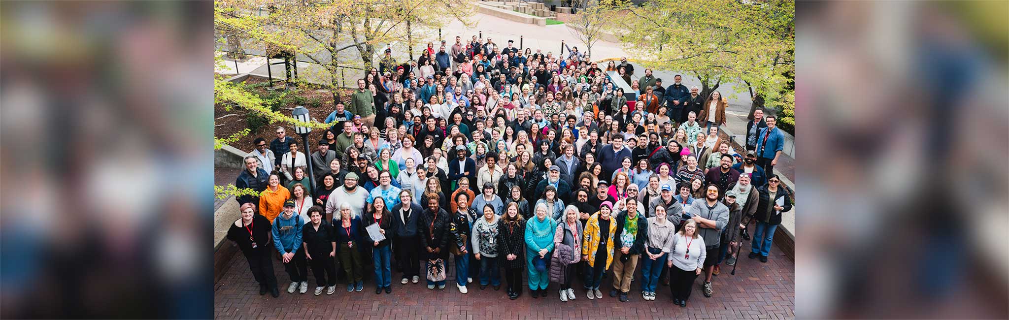 An overhead image of the OSF company members standing together in a large group.