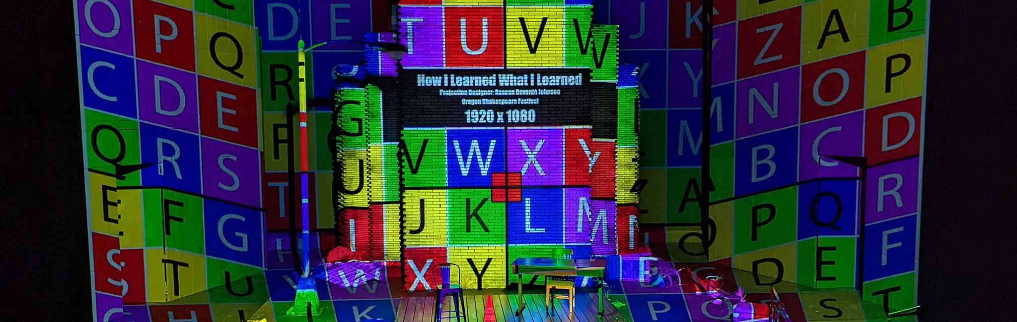 A colorful projection of letter tiles.